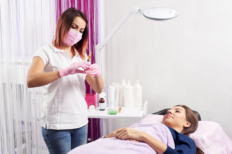 woman receiving botox treatment from a non-medical beauty therapist