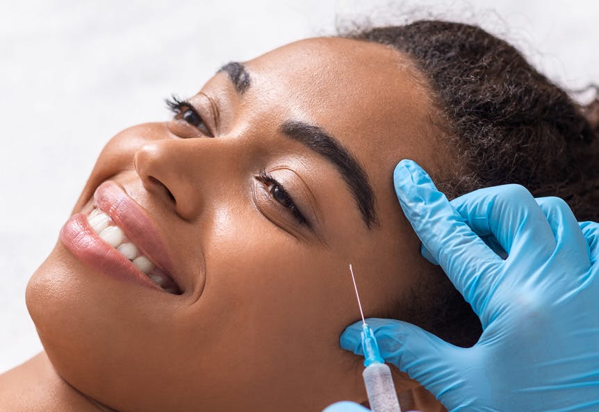 Young woman receiving botox injection