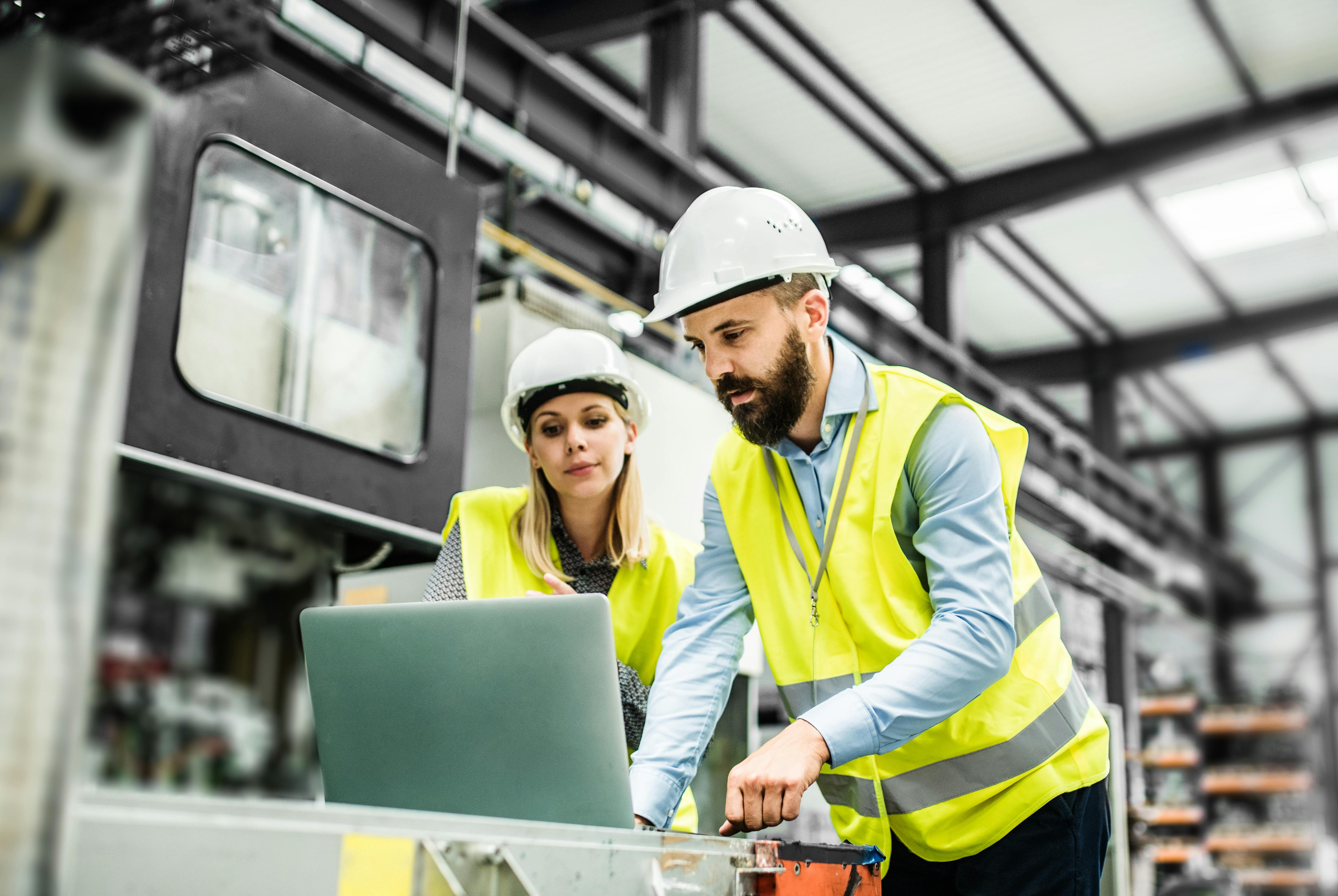 Workers evaluating the thermal efficiency of the insulation paper in a factory.