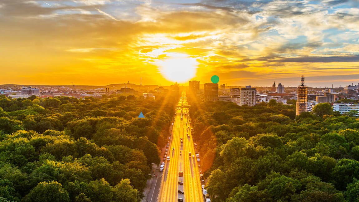 Sun setting over a city and motorway