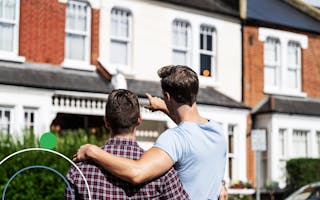 A couple viewing a new house to buy from outside the property in England
