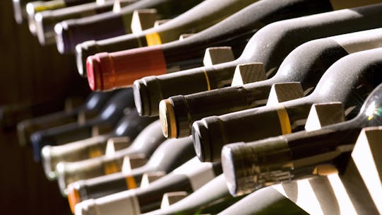 Wine bottles on a rack - the outcome of a good day's wine investing