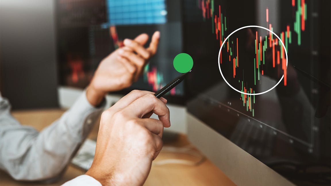Man sat in front of monitor looking at investment returns in 2022