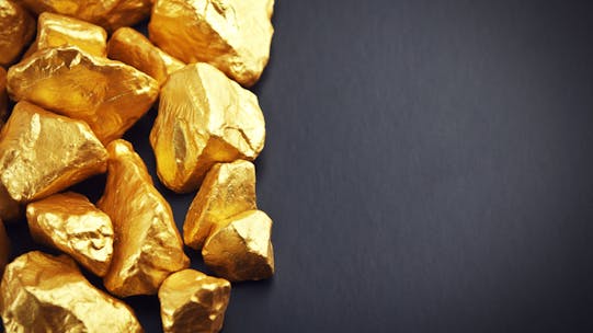 Gold nuggets on a black background. Closeup