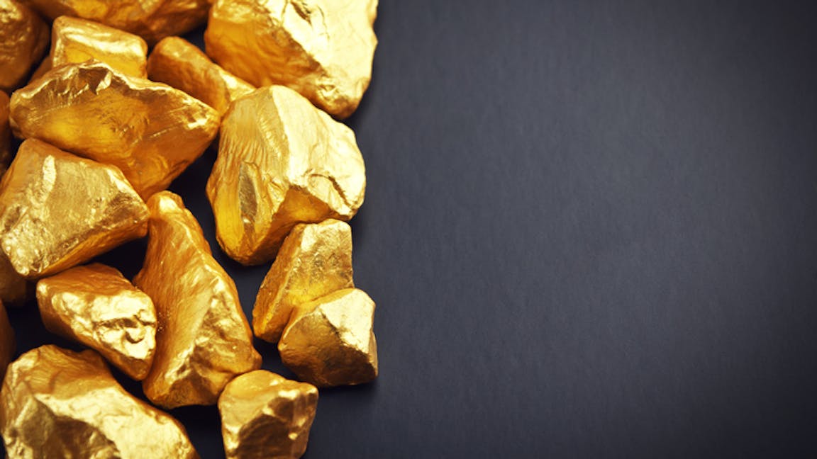 Gold nuggets on a black background. Closeup