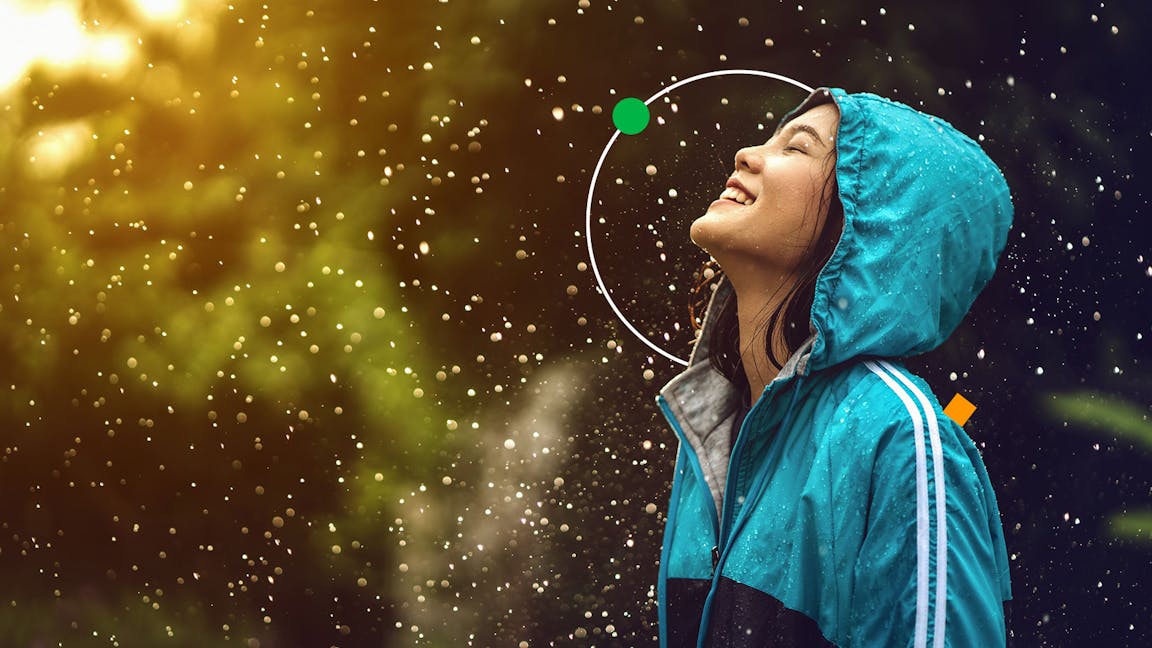Women looking up in a rain shower