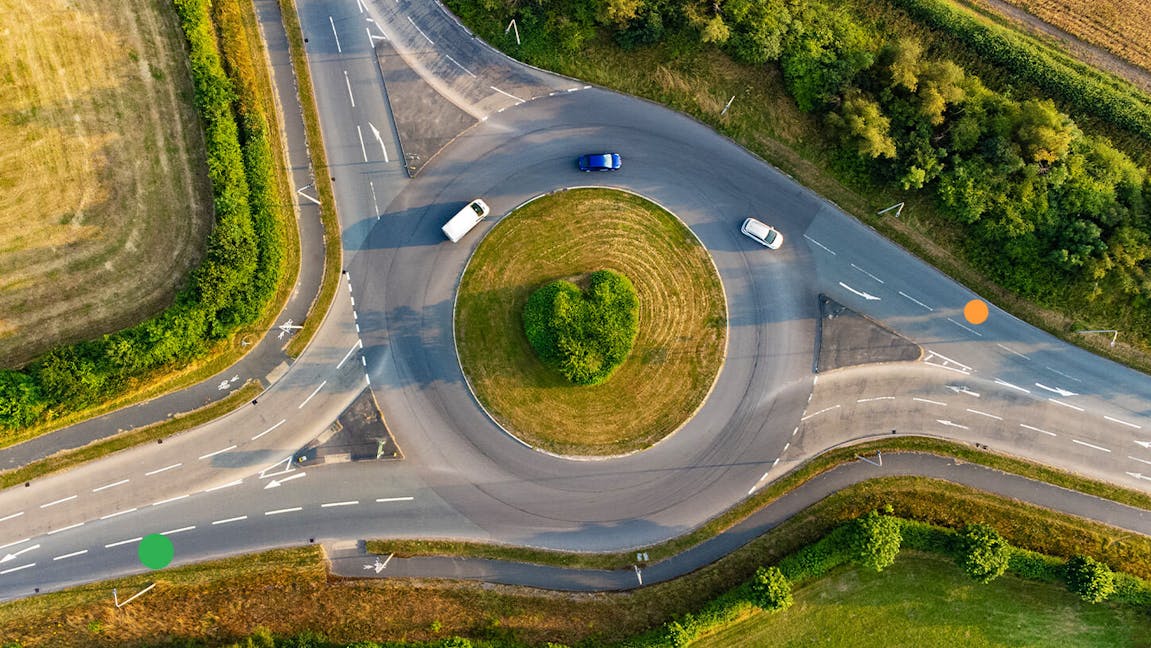 Image shows a motorway roundabout in the middle of fields.