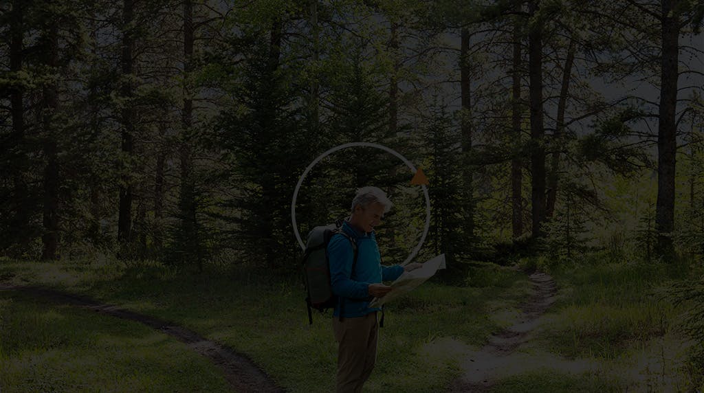 Man reading map in the woods