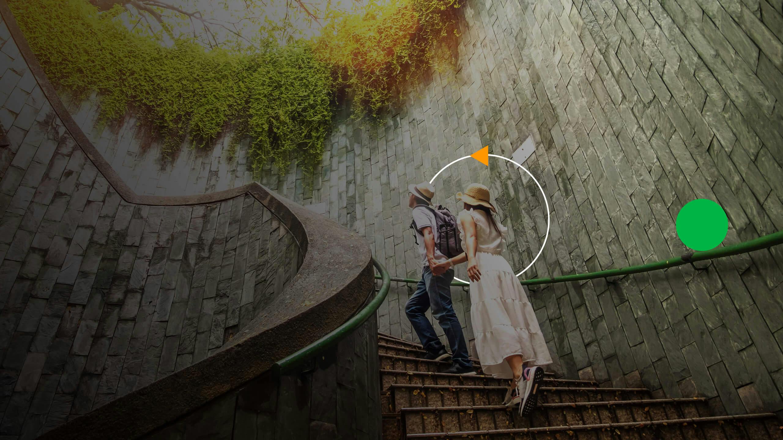 A couple walking up the stairs holding hands 