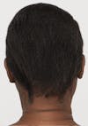 The back of a woman's head with short brown hair that's moisturized and strengthened after using Strand Defender Conditioner.