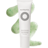 White bottle of Nutrafol Build-Up Blocker Scalp Microbiome Exfoliating Mask with green scalp exfoliator gel behind the bottle.