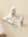 Three white bottles of Nutrafol Scalp Care.