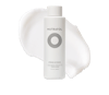 White bottle of Nutrafol Strand Defender Lightweight Protective Conditioner with white cream texture shown behind the bottle.