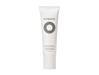 White bottle of Nutrafol Build-Up Blocker Scalp Microbiome Exfoliating Mask with green scalp exfoliator gel behind the bottle.|Exfoliating scalp mask