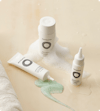 Three white bottles of Nutrafol Scalp Care.