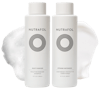 White bottles of Nutrafol Strand Defender Conditioner and Root Purifier Shampoo with white cream texture behind the bottles.