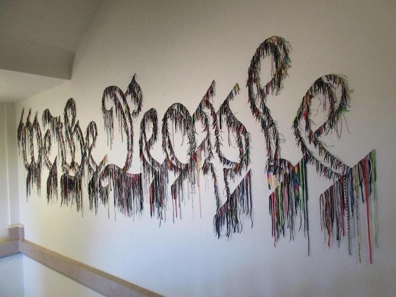 We the people artwork done in shoe laces by Nari Ward
