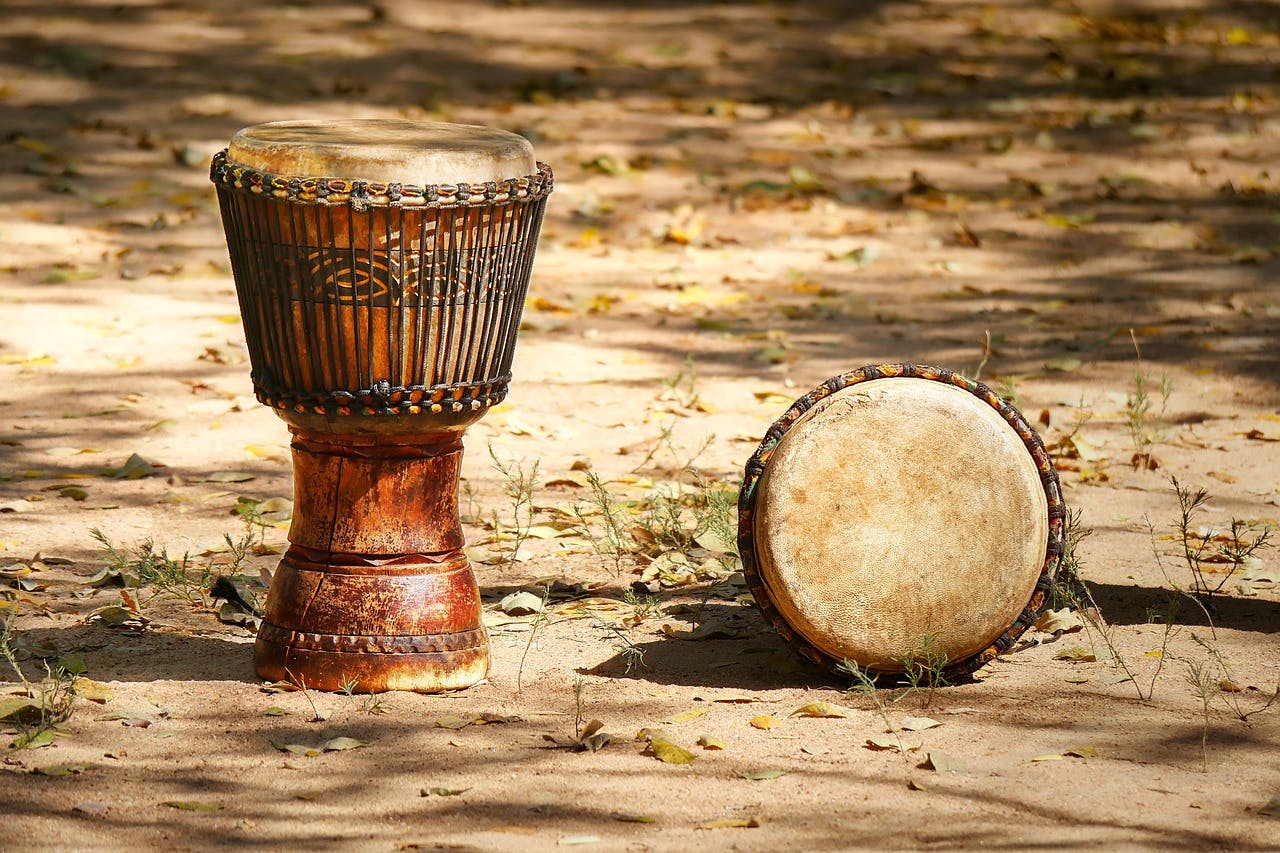 west African drums sitting on the ground outside