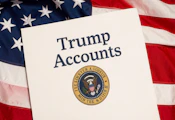 A sheet of paper titles "Trump Accounts" with presidential seal, with a backdrop of a US flag
