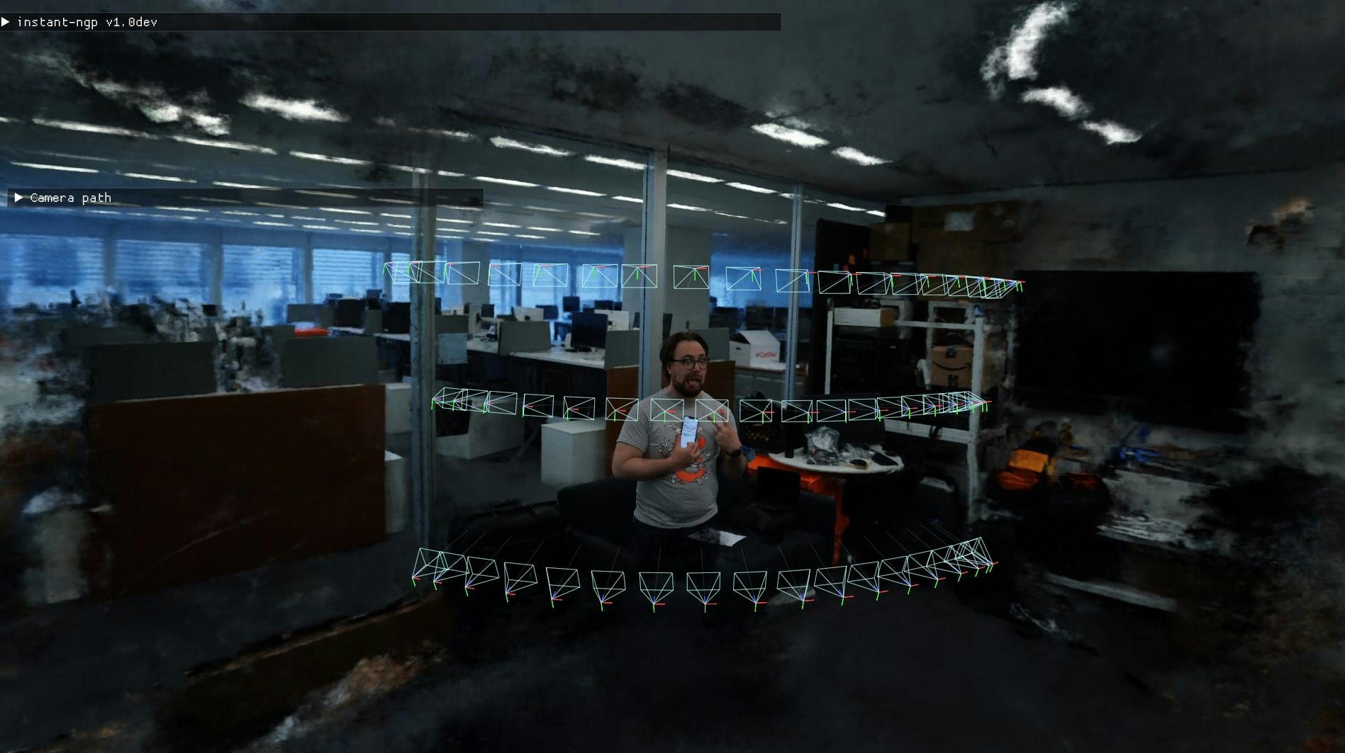 An image of a man posing in the middle of The New York Times office floor. Overlaid on the image is a 3D diagram and a line of code in the top left corner.