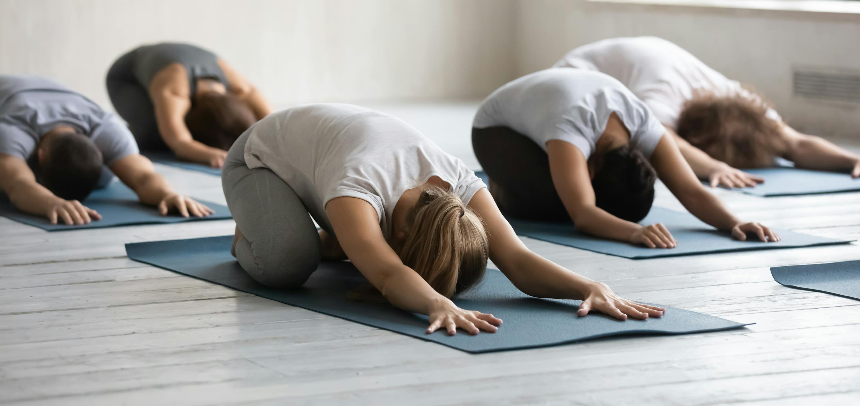 yoga participants in childs pose