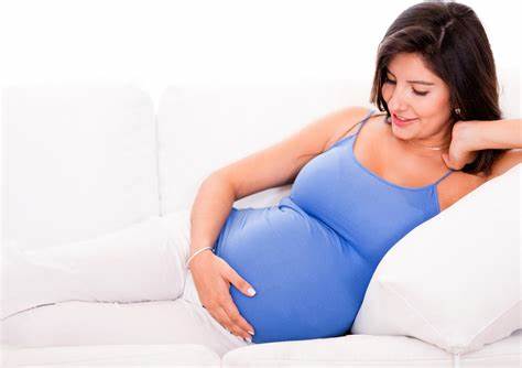 pregnant woman holding her stomach
