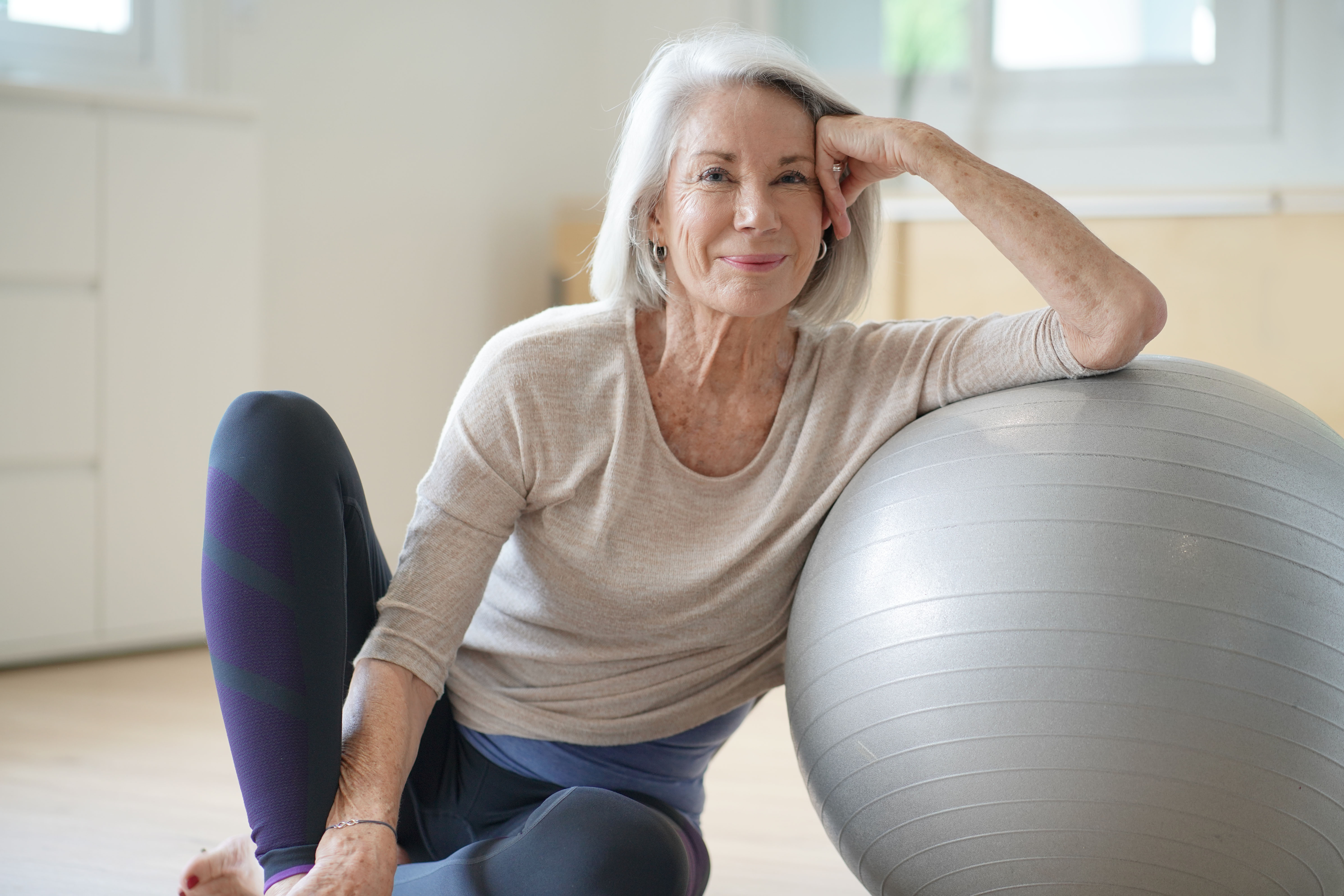 an older lady with a yoga ball