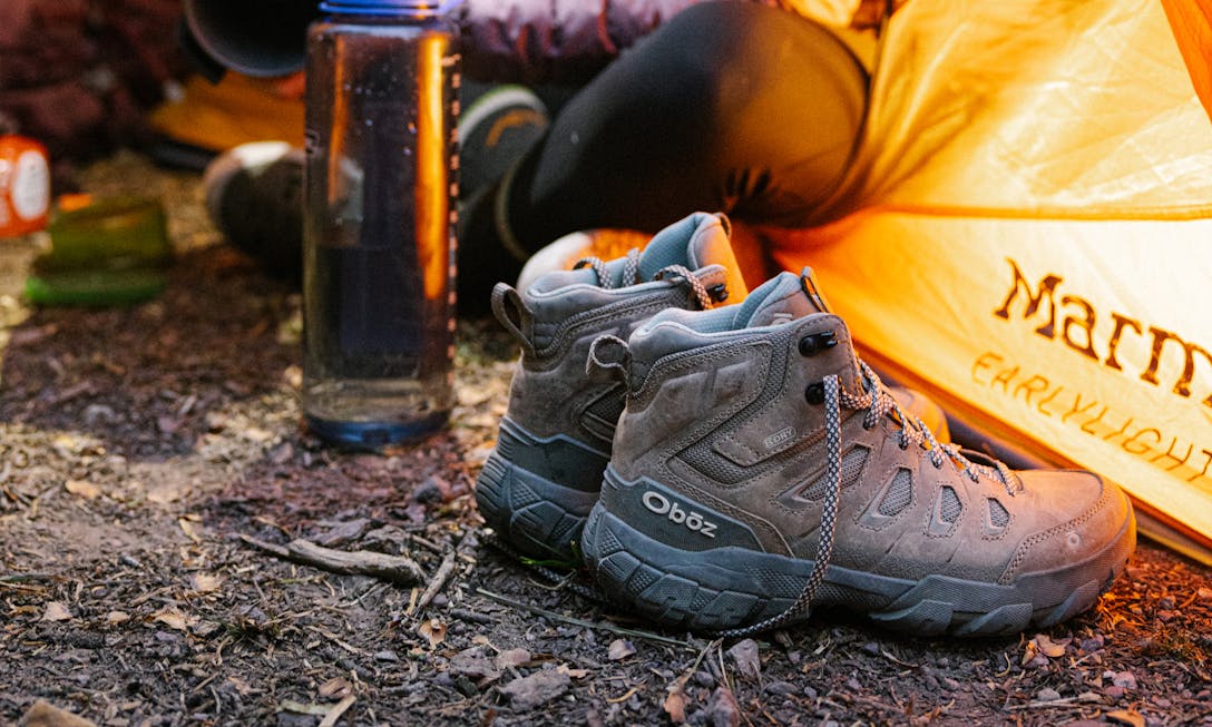 Oboz Sawtooth X Mid Waterpoof hiking boot at a camp site.