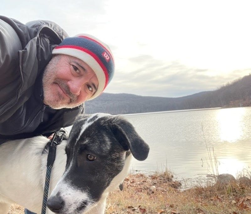 Oboz employee with his dog at the lake.