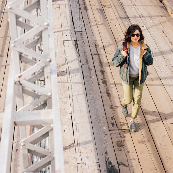 Woman walking on bridge in Oboz Jeanette casual shoes.