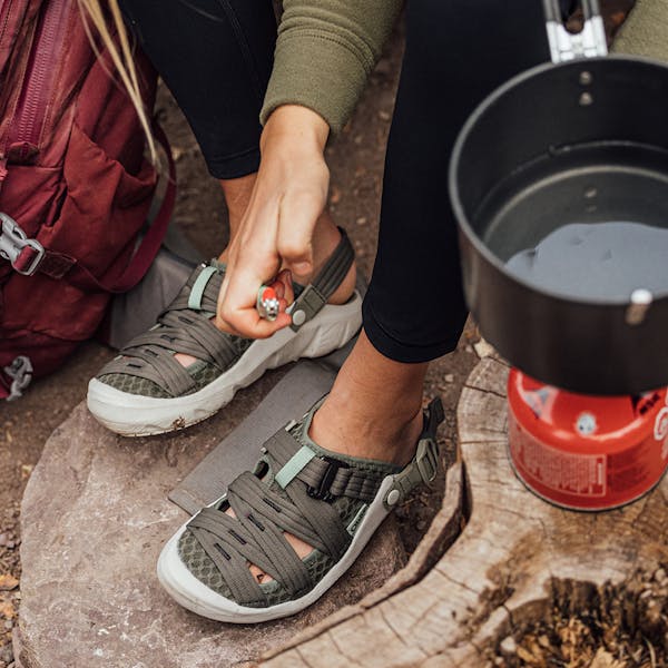 Cooking a portable stove meal in the Whakatā Trail recovery sandal.