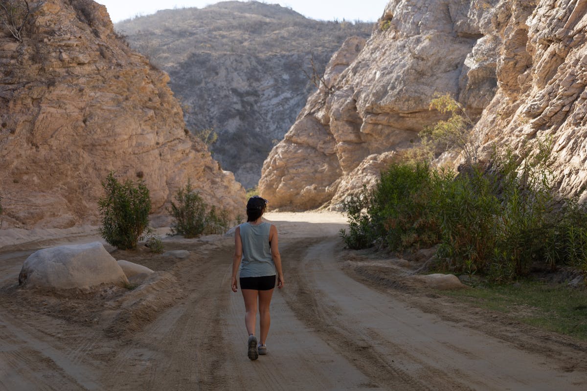 Individual hiking on a dirt road in Baja, California. Image credit: Bearfoot Theory