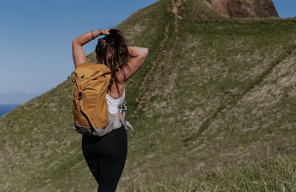 Lindsay Kagalis tying hair before ascending the top of a mountain in the Women's Bozeman Mids shoes