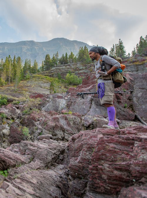 Derick Lugo hiking in the Sawtooth X Low in a mountain landscape.
