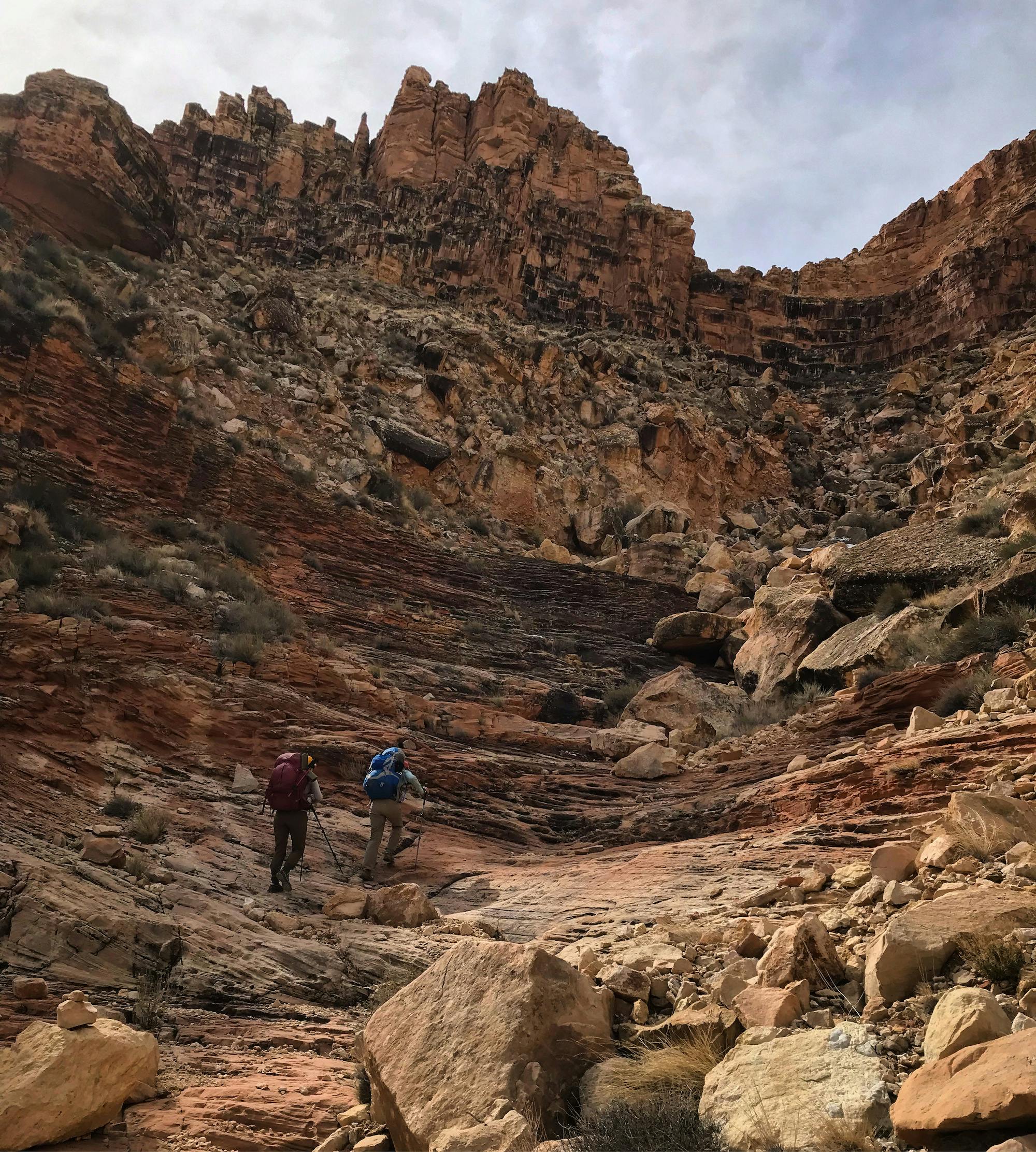 Two hikers hiking up the ridge