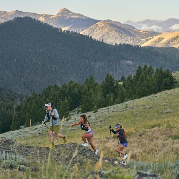 Group of hikers trail running up a mountain in Montana wearing Oboz trail shoes.