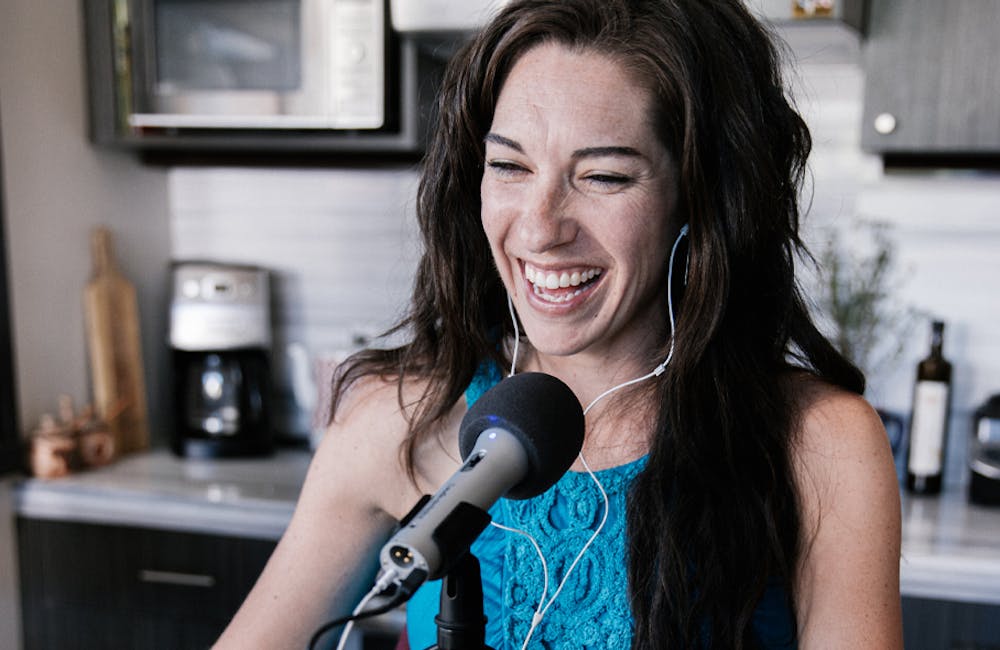 Jackie Nourse recording a podcast with a microphone on top of a cooking pot