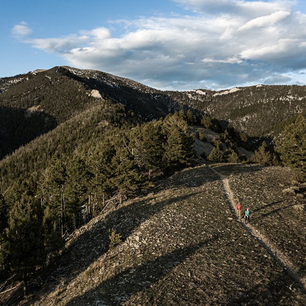 Two hikers on a steep mountain trail near Bozeman, MT.