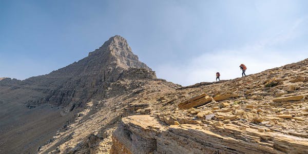 Man and woman hiking a mountain ridge in Oboz