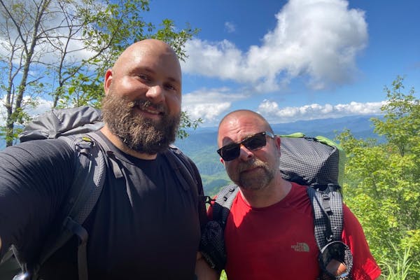 Two individuals backpacking the Smokies on a bright and sunny day