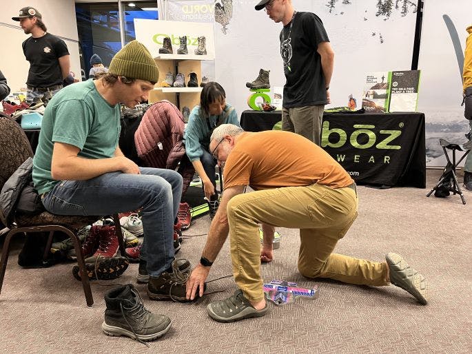 Person being fit for an Oboz hiking boot at a retail store. 