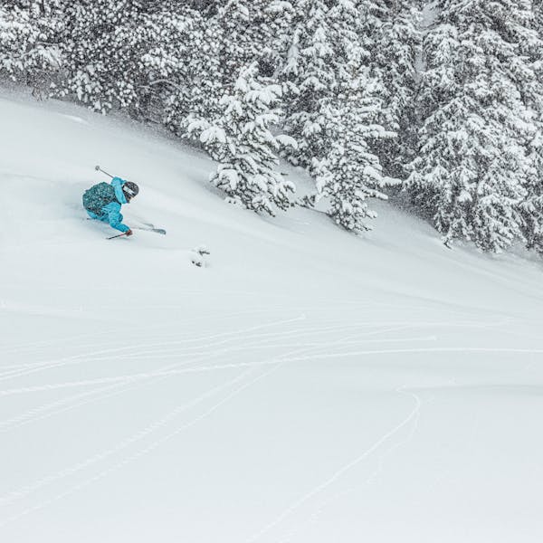 A woman skiing in the Montana backcountry with Oboz and Skida