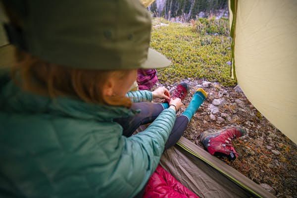 Keeping her feet warm and dry in the Bridger Mid Waterproof while camping