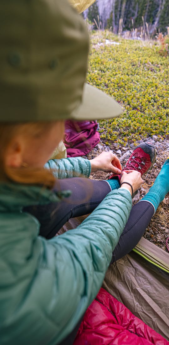 Keeping her feet warm and dry in the Bridger Mid Waterproof while camping