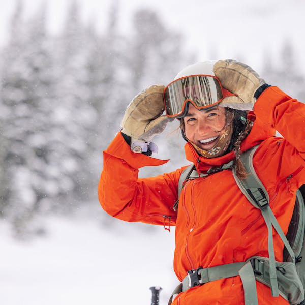 A woman in the Montana backcountry wearing the  Oboz and Skida collab buff