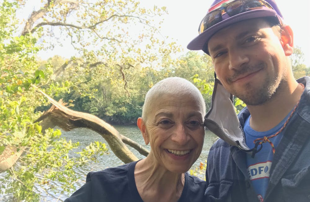 Alexi Kimiatek and his mother enjoying the sun near a body of water