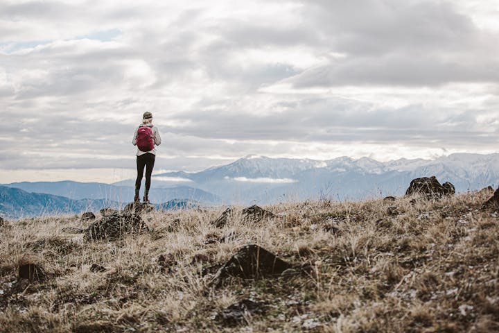 Hiker looking at a mountain range in Montana.