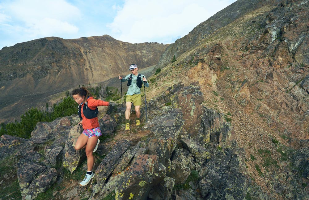 Two hikers descending a rocky ridgeline in the Oboz Katabatic Winds.
