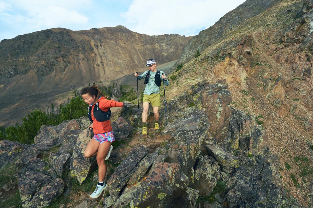 Two hikers descending a rocky ridgeline in the Oboz Katabatic Winds.