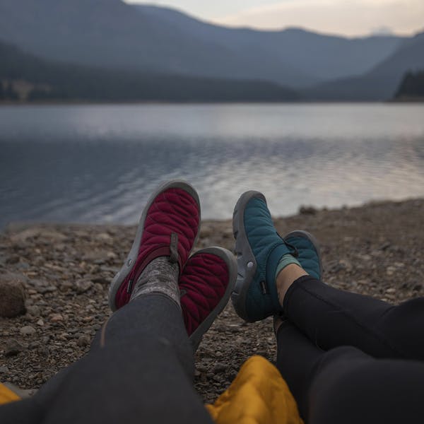 Relaxing on the shore of Hyalite lake in the women's Oboz Whakata Puffy slippers.